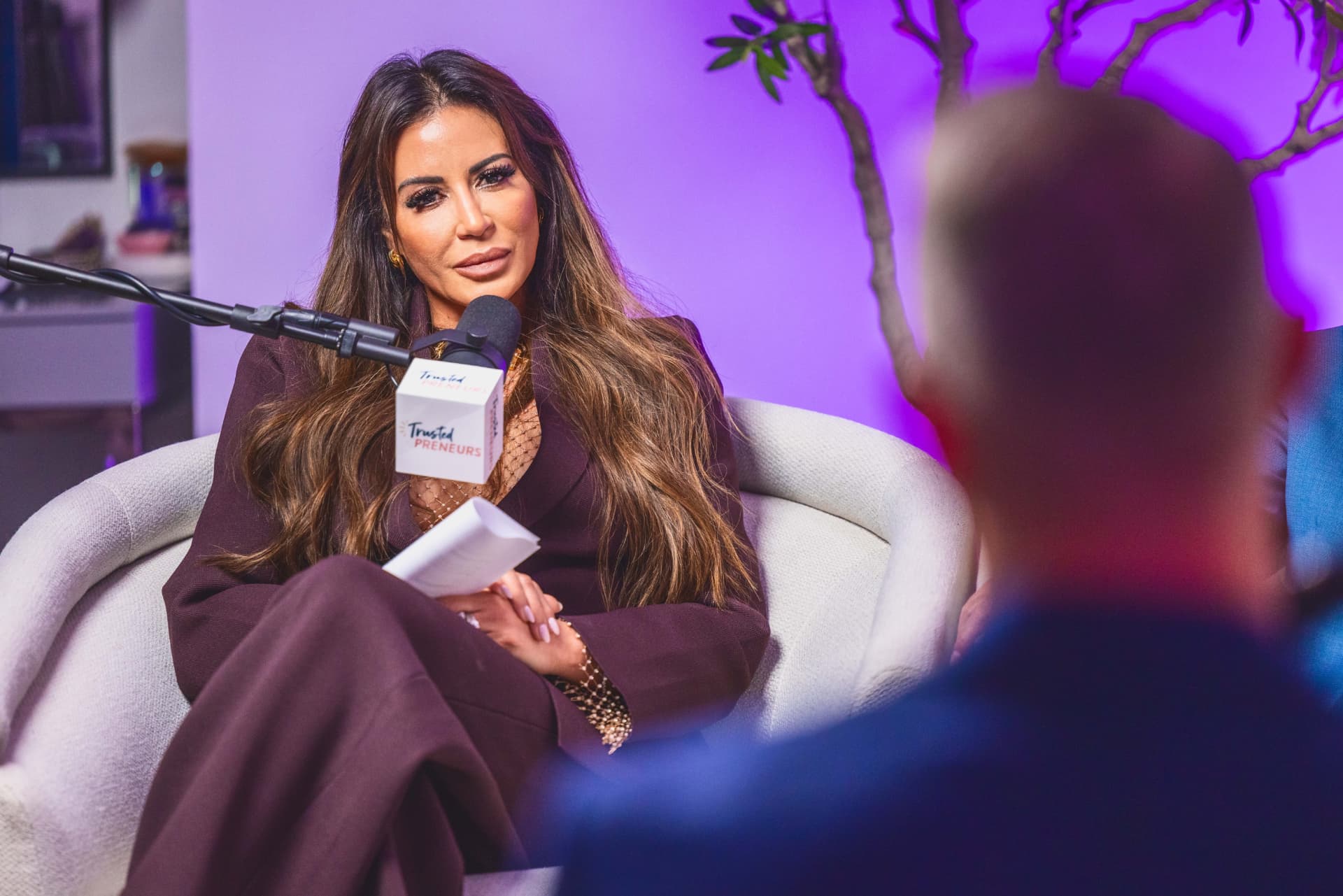 Madeline Ricci listening at the microphone during a Trustedpreneurs recording